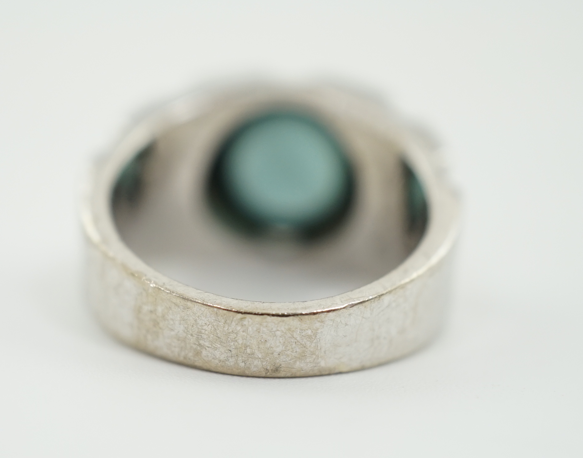 An 18ct white gold and single stone blue green cabochon tourmaline set ring